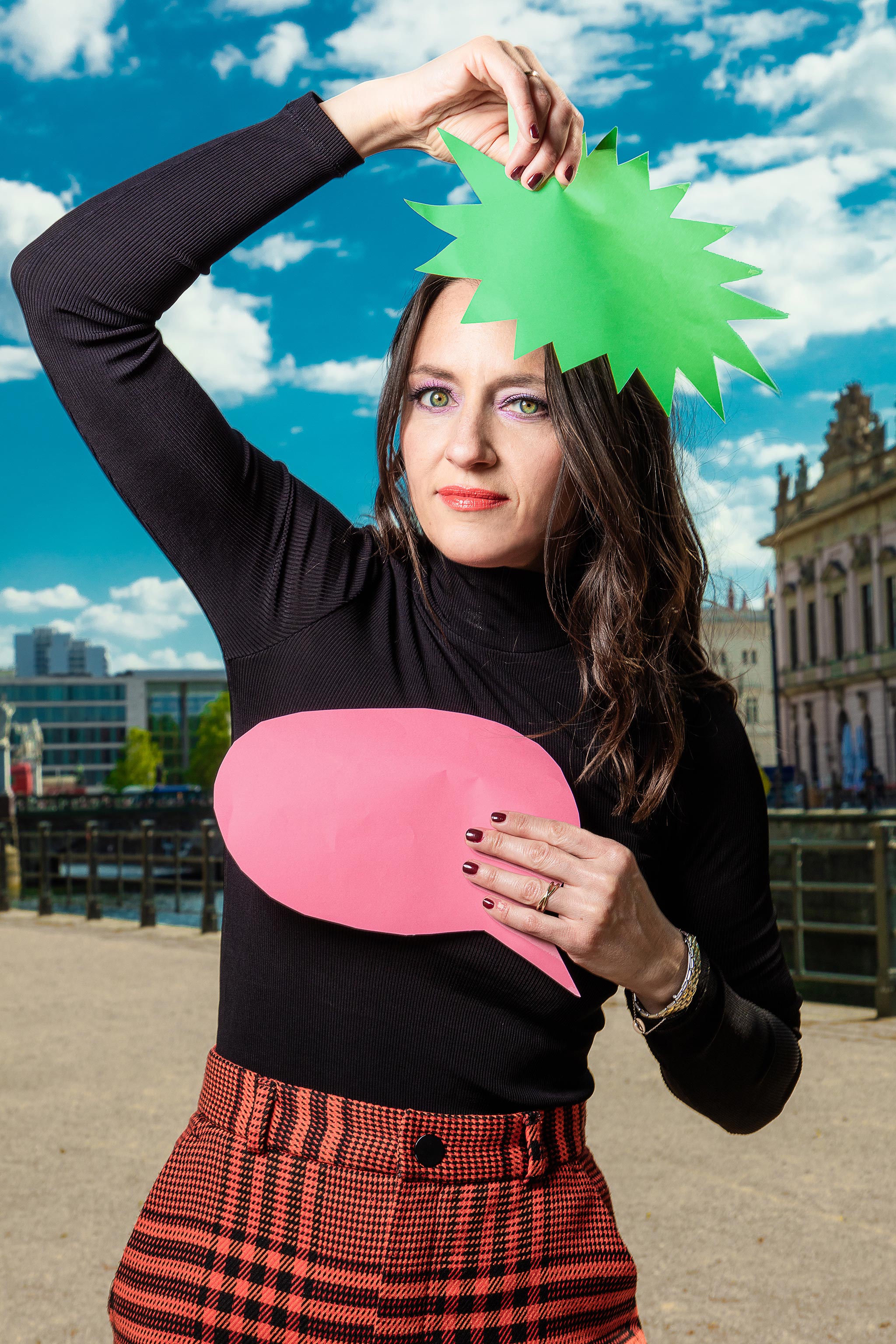 Women holds paper speech bubbles in the air