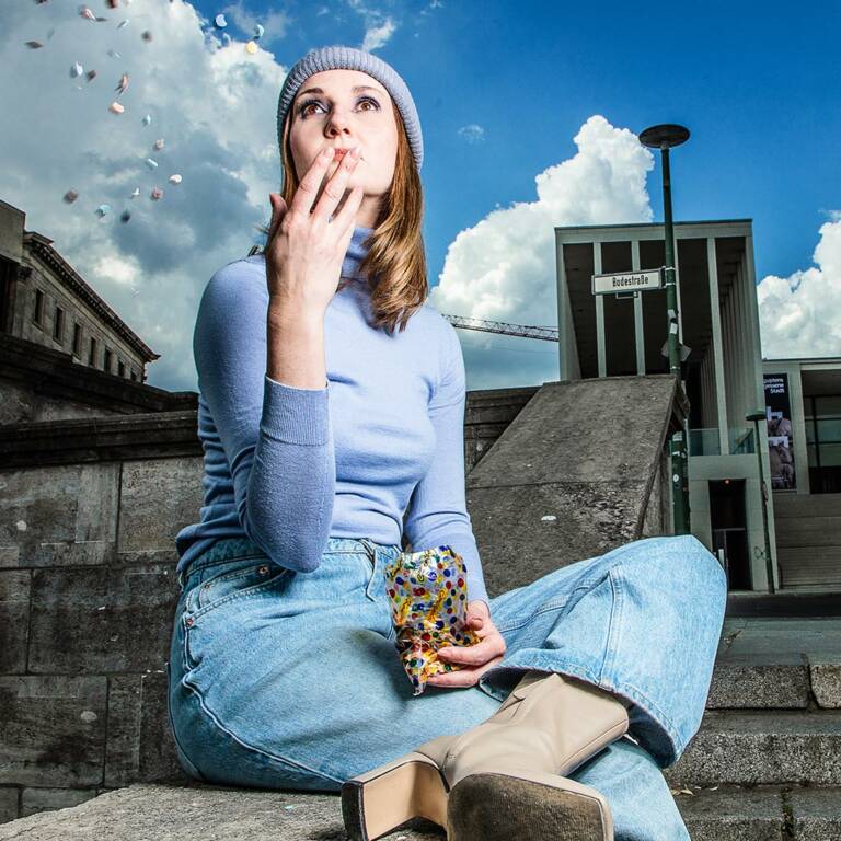 Frau wirft Konfetti in die Luft