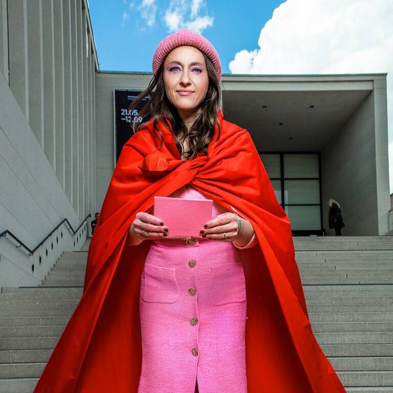 Woman standing on a staircase with notes in her hand